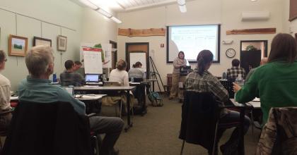workshop participants sitting and watching a presentation