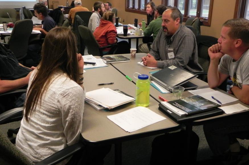 DNR foresters Mike Lichter (far right) and Scott Burns (second from right) discuss adaptation ideas with co-workers at a workshop. 